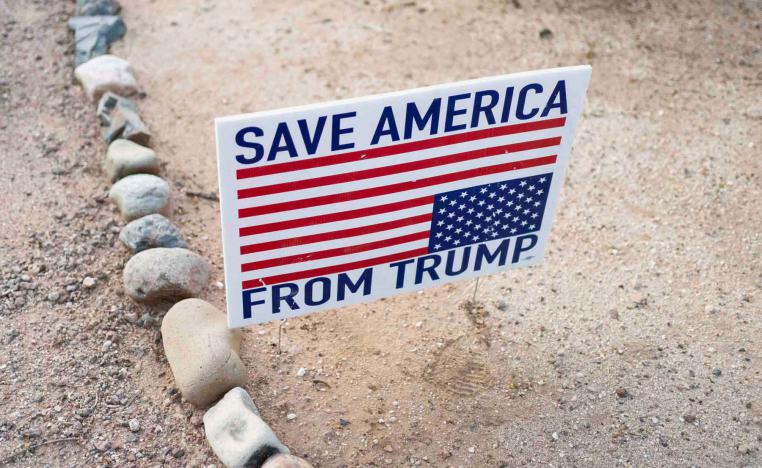 A sign reads “Save America from Trump” outside a “Veterans for Mendoza” event for Democratic candidate for Arizona Congressional District 6 JoAnna Mendoza, in Tucson, Arizona, December 16, 2025. 