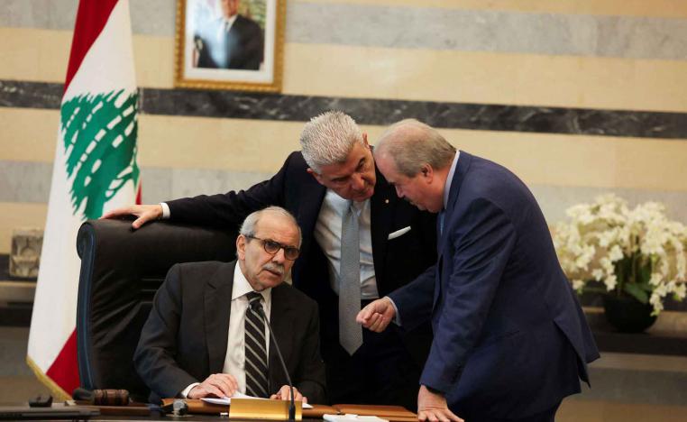 Lebanese Prime Minister Nawaf Salam speaks with Finance Minister Yassine Jaber and Lebanese Industry Minister Joe Issa el-Khoury during a cabinet meeting in Beirut, December 23, 2025. 