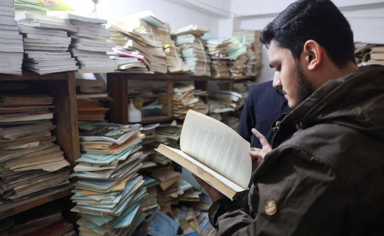 A customer reads a book inside a basement dedicated to books near Al-Mutanabbi Street in Baghdad.
