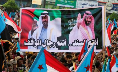 People hold a banner with images of the Emirati President Sheikh Mohamed bin Zayed Al Nahyan and Saudi Crown Prince Mohammed bin Salman during a rally organised by Yemen’s Southern Transitional Council in Aden, December 21, 2025. 