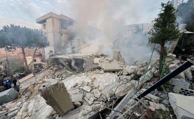 People inspect a damaged site after Israel’s military said it struck targets in two southern Lebanese towns, December 4, 2025. 