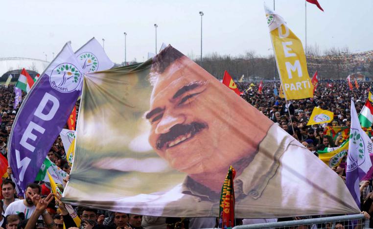 Supporters of the pro-Kurdish Peoples Equality and Democracy Party (DEM Party) hold a banner with an image of jailed Kurdish militant leader Abdullah Ocalan during a gathering in Istanbul, March 23, 2025. 