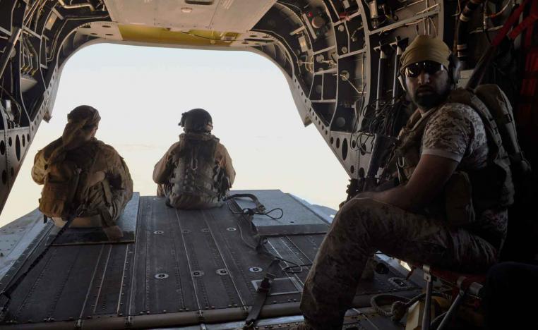 A 2015 file picture shows Emirati soldiers standing guard out the rear gate of a Chinook military helicopter travelling from Saudi Arabia to Yemen. 