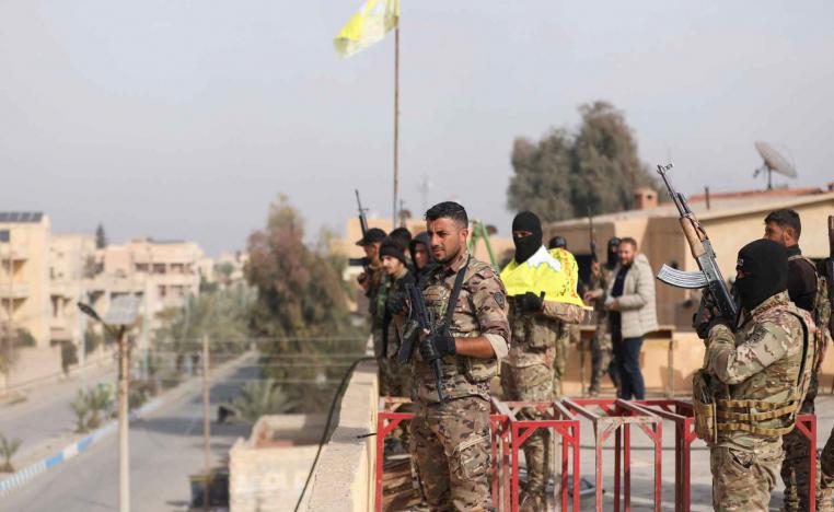 Members of the Kurdish-led Syrian Democratic Forces (SDF) hold weapons in Deir ez-Zor, December 7, 2024. 