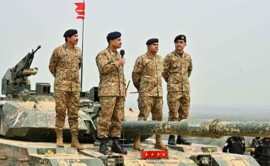 Chief of Army Staff of Pakistan Asim Munir holds a microphone during his visit at the Tilla Field Firing Ranges (TFFR), in Mangla, Pakistan, May 1, 2025. 