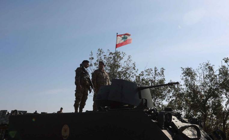 Lebanese army members stand on a military vehicle in Alma Al-Shaab, near the border with Israel, southern Lebanon, November 28, 2025. 