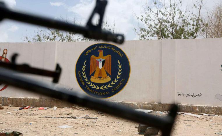 The emblem of the STC is seen between weapons in Ataq, Yemen.