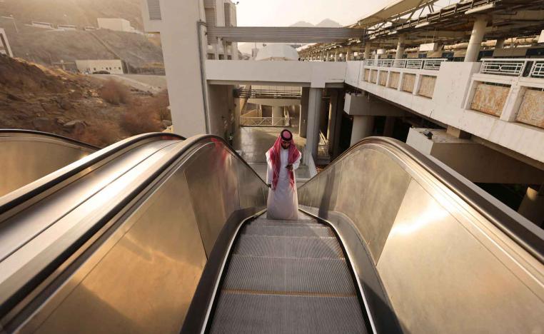 A Saudi man rides an escalator at a train station in Mecca, Saudi Arabia. 