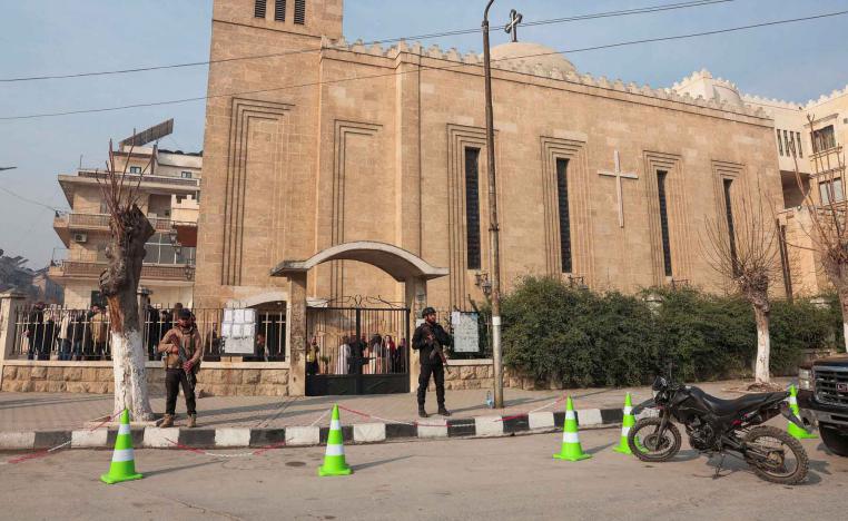 Members of the security forces stand in front of the St. Joseph Chaldean Cathedral on the day Christians attend Christmas Mass celebrations at the Chaldean Catholic Church, in Aleppo, Syria, December 25, 2025. 