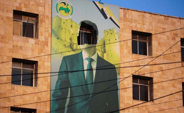 A damaged poster of Syria’s former president Bashar al-Assad in Aleppo, November 30, 2024. 
