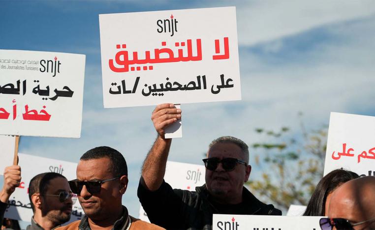 Tunisian journalists rally near the governments office, holding signs to protest press restrictions, call for greater freedom on November 20, 2025