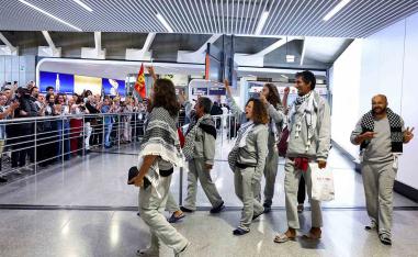 French activists from the Gaza-bound Global Sumud Flotilla gesture upon arrival at Charles de Gaulle Airport near Paris on May 22