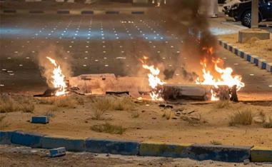 Debris burns on the ground in a parking lot following reports of missile and drone attacks, in Sabah Al Nasser, Kuwait