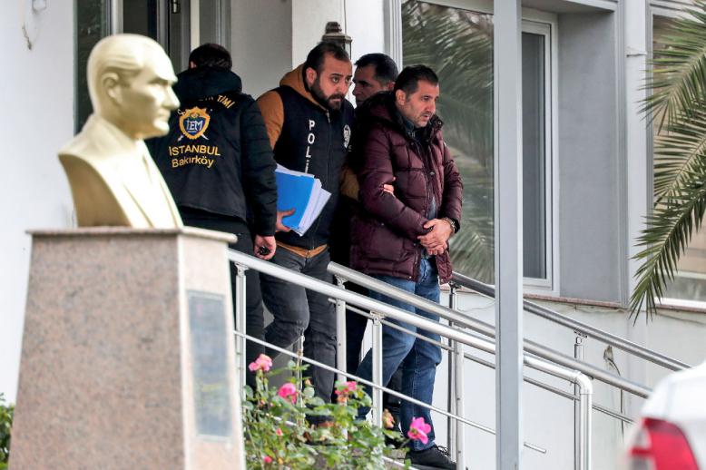 Turkish police officers escort suspects accused of involvement in Nissan's former CEO Carlos Ghosn passage through Istanbul
