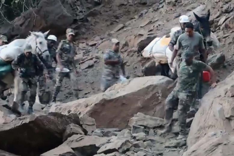Braving the rugged terrain and aftershocks to bring relief to quake-affected villagers