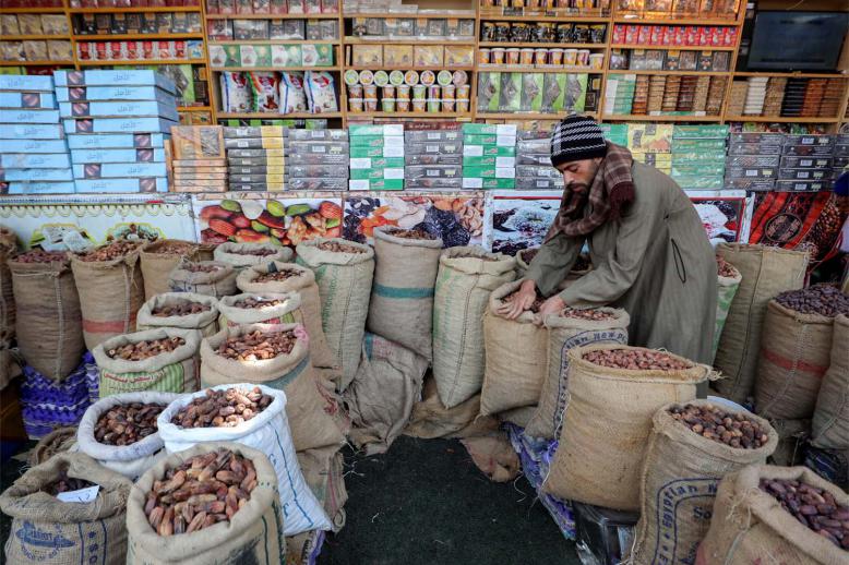 An Egyptian seller waits for customers at his dates shop ahead of the Muslim fasting month of Ramadan