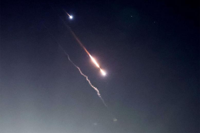 Objects are seen in the sky above Jerusalem after Iran launched drones and missiles towards Israel