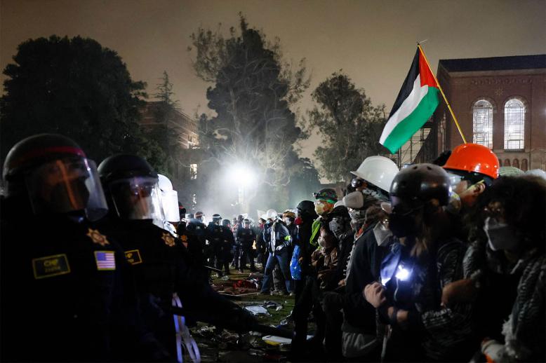 Police face-off with pro-Palestinian students after destroying part of the encampment barricade on the UCLA campus