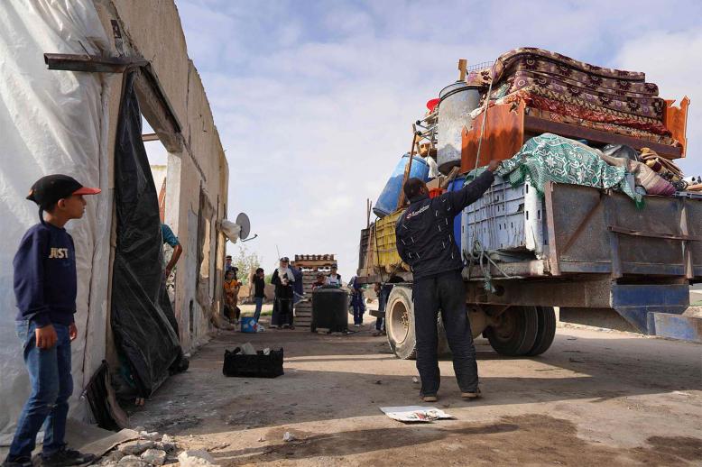 Displaced Palestinian families load their belongings on trucks to leave Rafah towards Khan Yunis