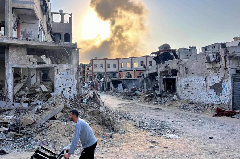 فلسطيني بالقرب من اطلال لأبنية مدمرة بالقصف في غزة