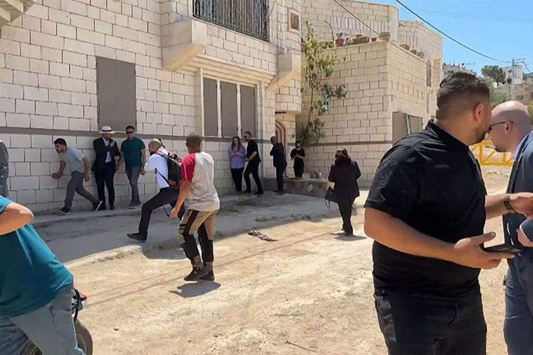 Members of a diplomatic delegation from the European Union reacting after shots were fired as they gathered in Jenin camp