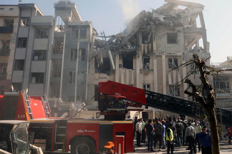 Rescuers work at the scene of a damaged building in the aftermath of Israeli strikes, in Tehran