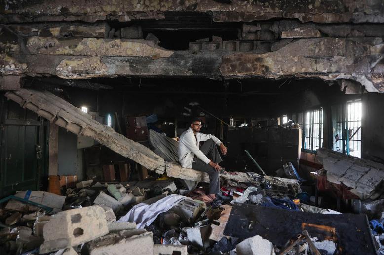 A man sits amid the debris at the Fahmi Al-Jarjawi School in Gaza City on May 26