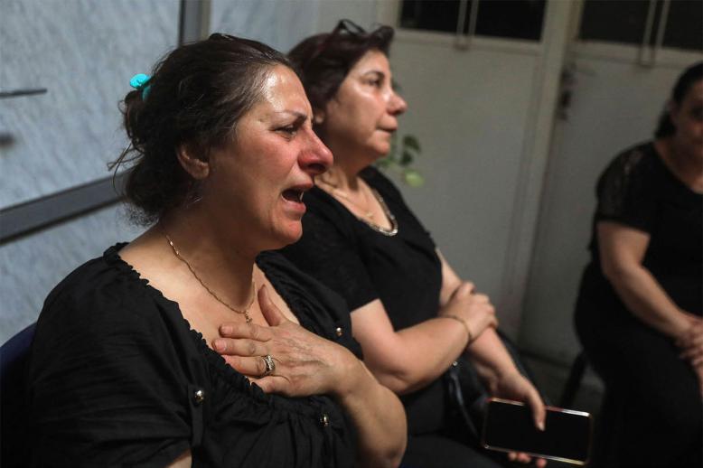  Relatives and friends mourn with members of the Bechara family who lost several members in the suicide attack at the Saint Elias church