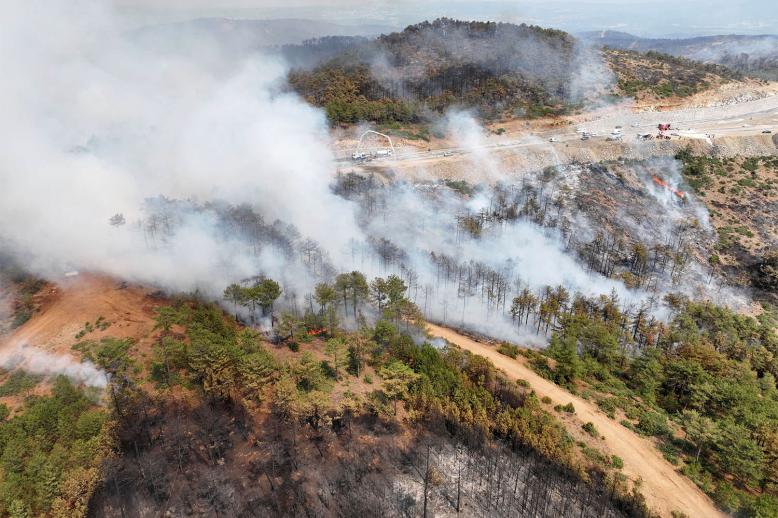 A drone view shows smoke rising from a wildfire burning in Harmancik in the northwestern Bursa province
