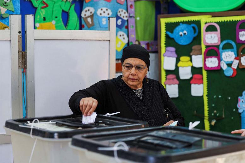 A woman votes at a school used as a polling station in Giza