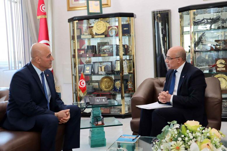 Tunisian Defence Minister Khaled Sehili speaks with US Ambassador Bill Bazzi during a meeting in Tunis, December 3, 2025. 