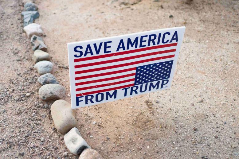 A sign reads “Save America from Trump” outside a “Veterans for Mendoza” event for Democratic candidate for Arizona Congressional District 6 JoAnna Mendoza, in Tucson, Arizona, December 16, 2025. 
