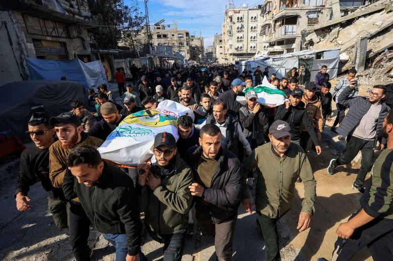 Mourners carry bodies during the funeral of Hamas senior commander Raed Saed and his aides, in Gaza City, December 14, 2025. 