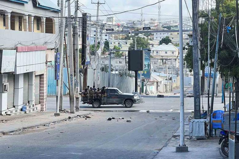 A truck carrying Somali security forces drives across a street ahead of a protest against Somalia's President