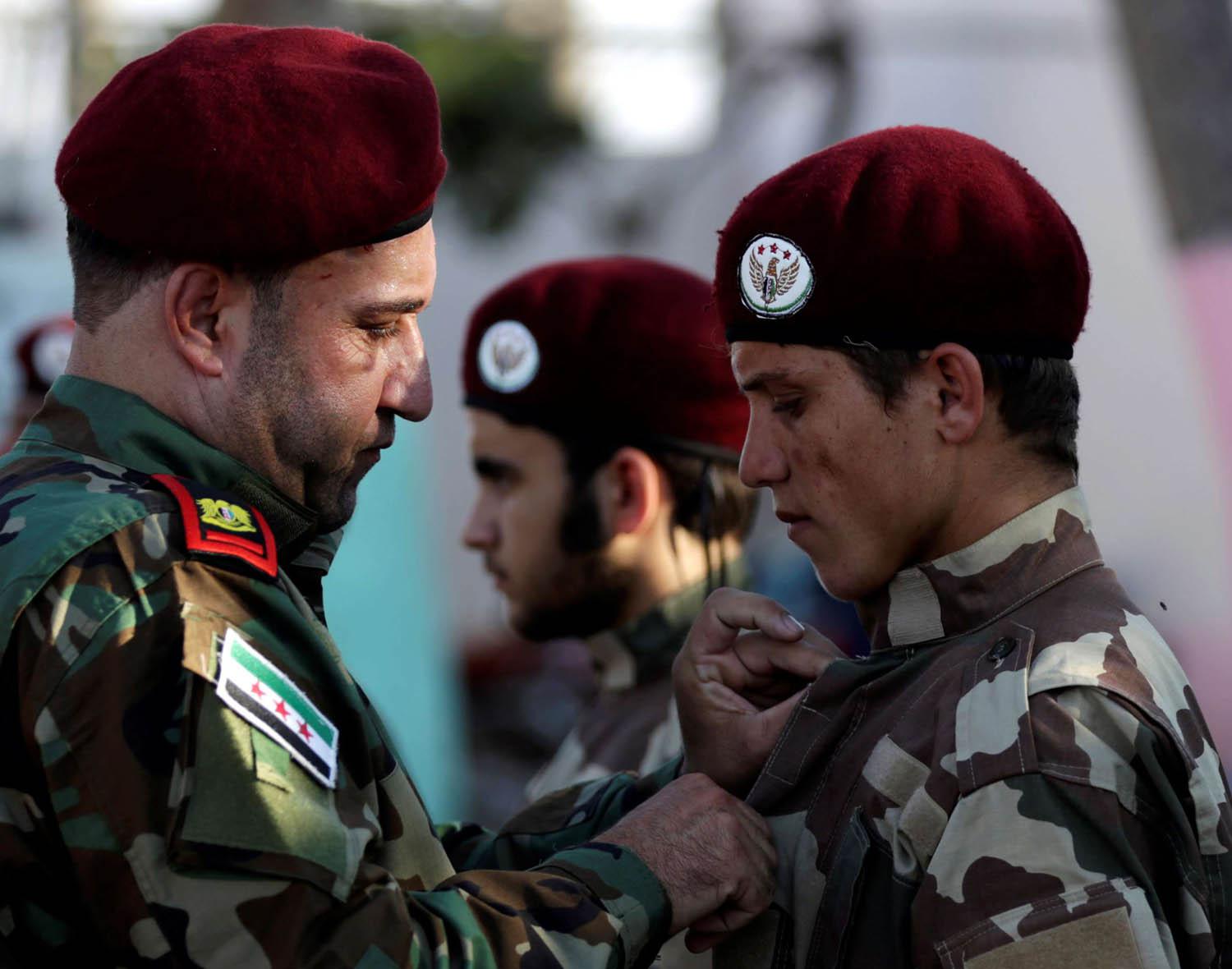 ضابط في الجيش الوطني السوري يقلد جنديا وساما