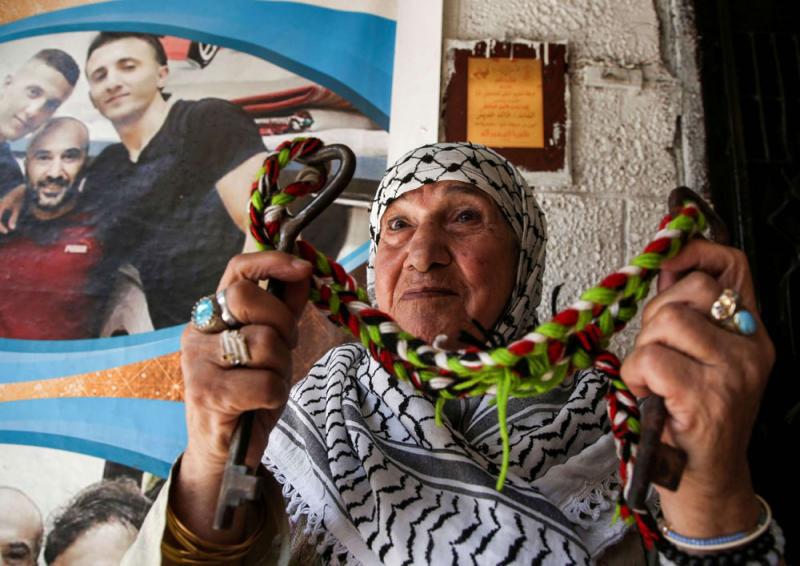 A Palestinian woman holds the key of her family’s home as she sits at the Balatah refugee camp in the occupied West Bank, on September 2.