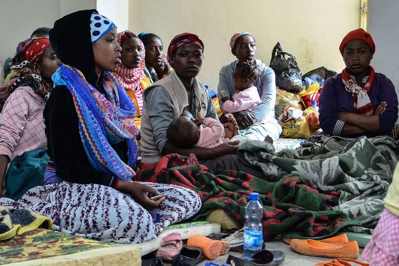 People who fled the violence in the Ethiopian capital Addis Ababa sit at a temporary shelter.