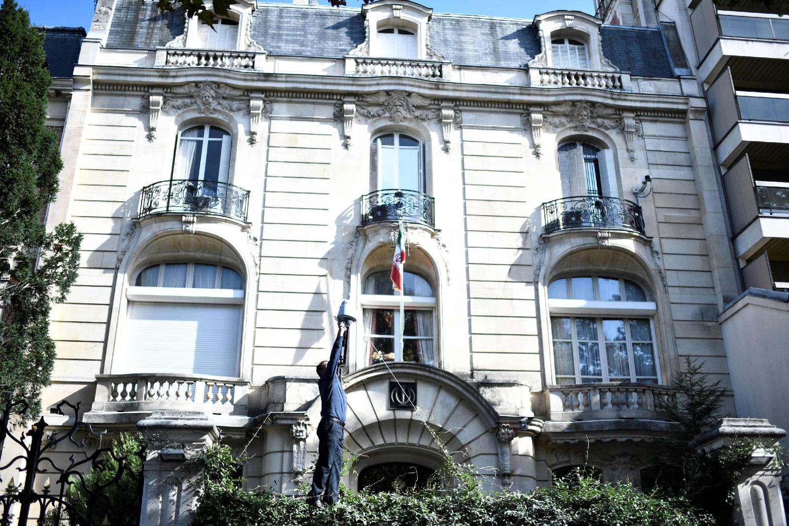 A man cleans the surveillance camera in the grounds of the Iranian Embassy in the French capital Paris.