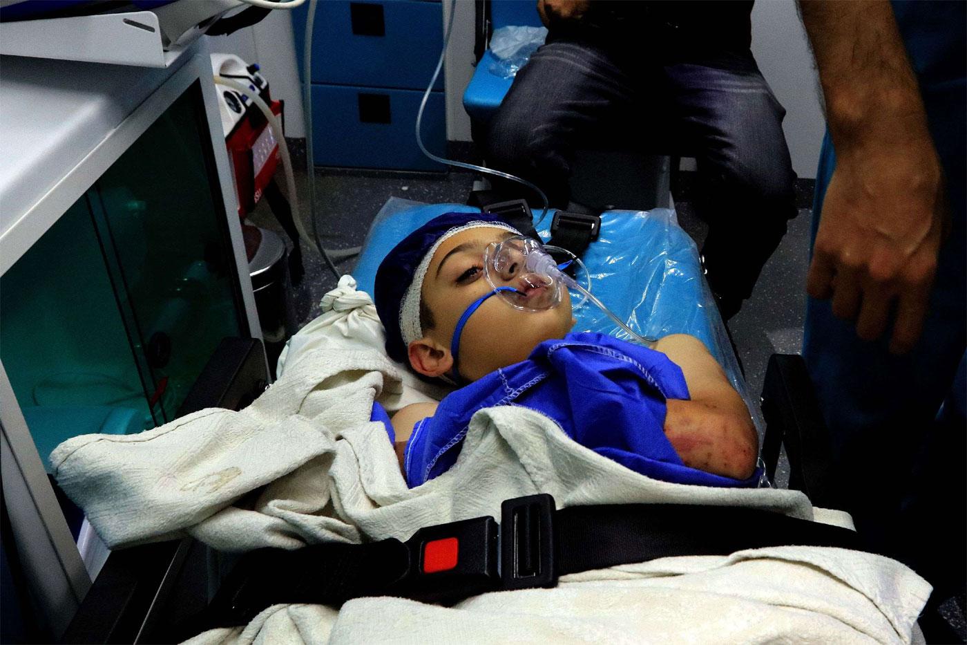 A wounded pupil lays on a stretcher at a hospital after a bus accident near the Dead Sea in Jordan 