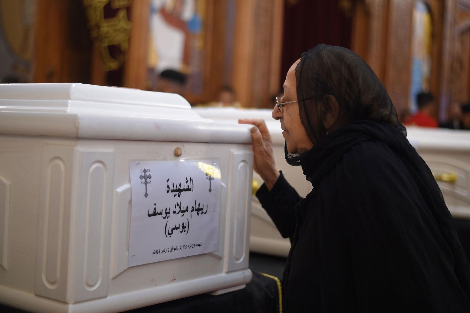 A relative of a slain Christian grieves during funeral service in Minya, Egypt.
