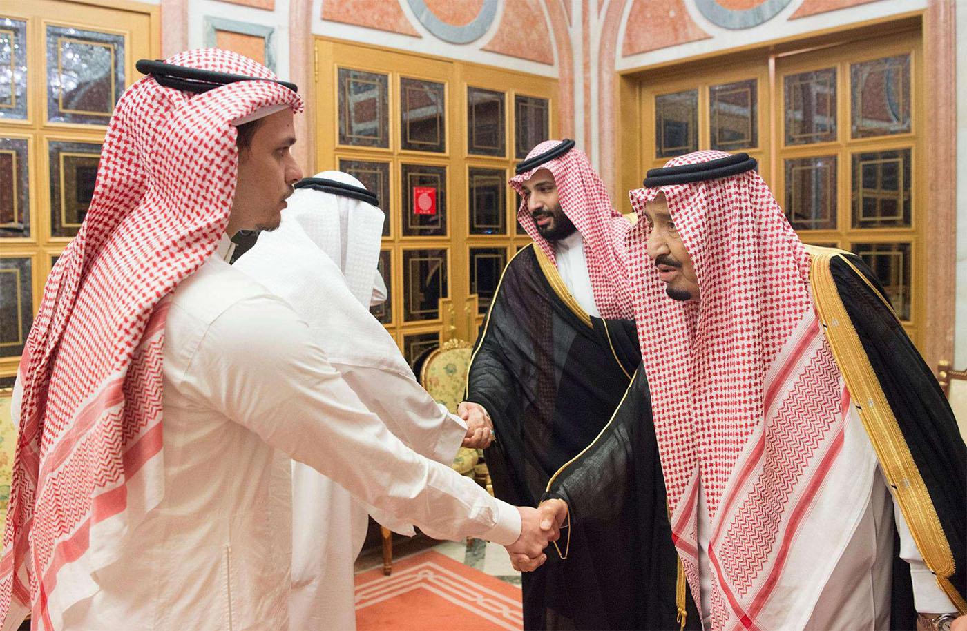 King Salman shakes hands with Khashoggi's son