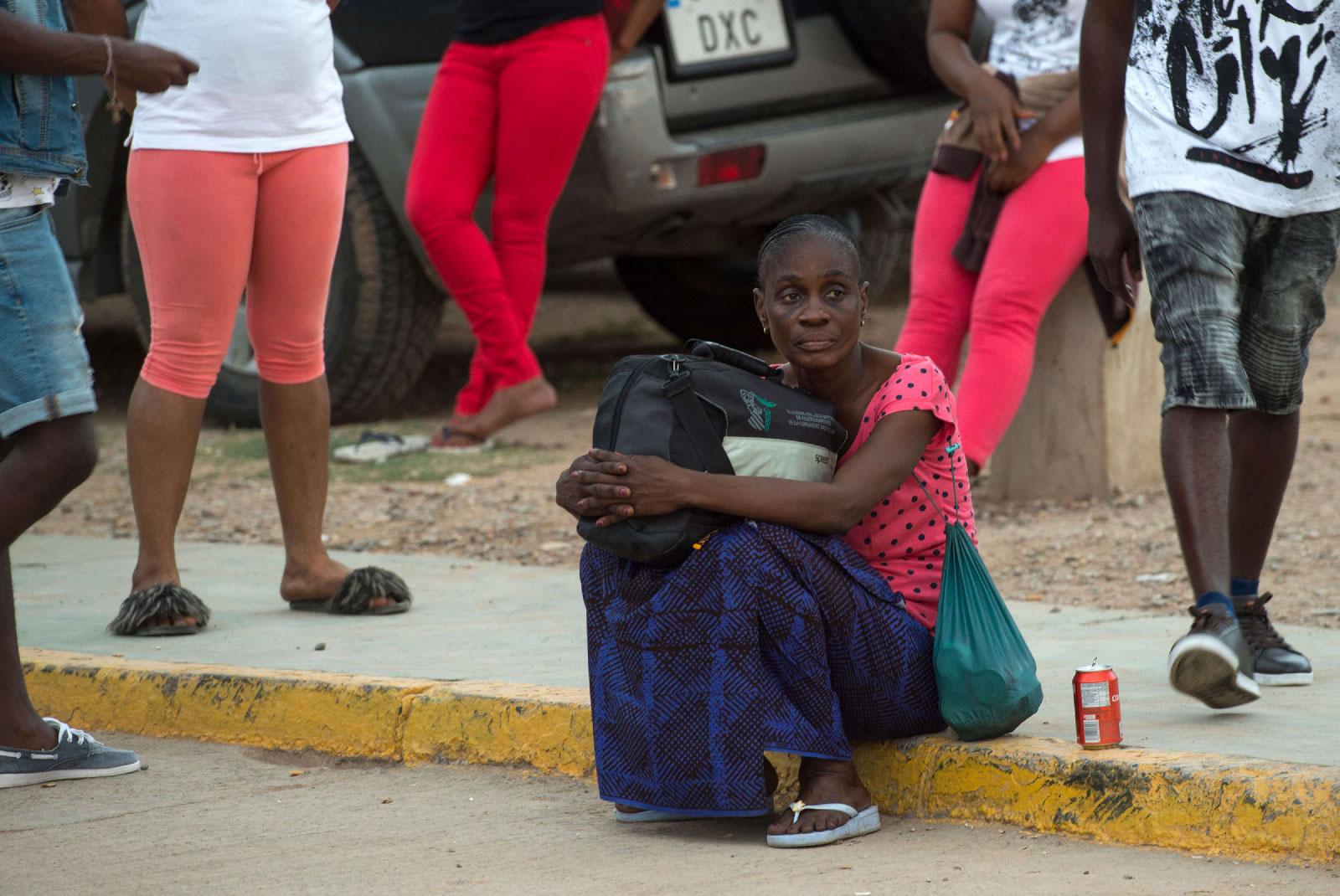 A Sub-Saharan migrant sits as she waits to leave the temporary centre for immigrants and asylum seekers in the Spanish enclave of Melilla on September 19 , 2018.