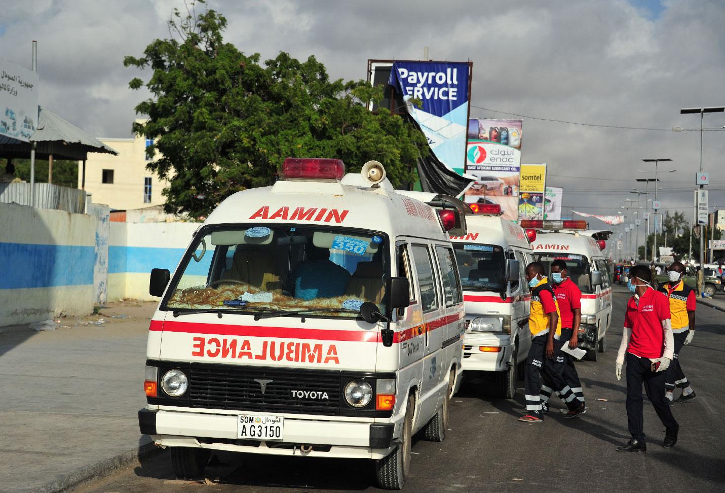 Somali ambulances carrying severely injured patients after an explosion in Mogadishu wait to access the airport where the wounded will be evacuated on Turkish military planes on October 16, 2017.