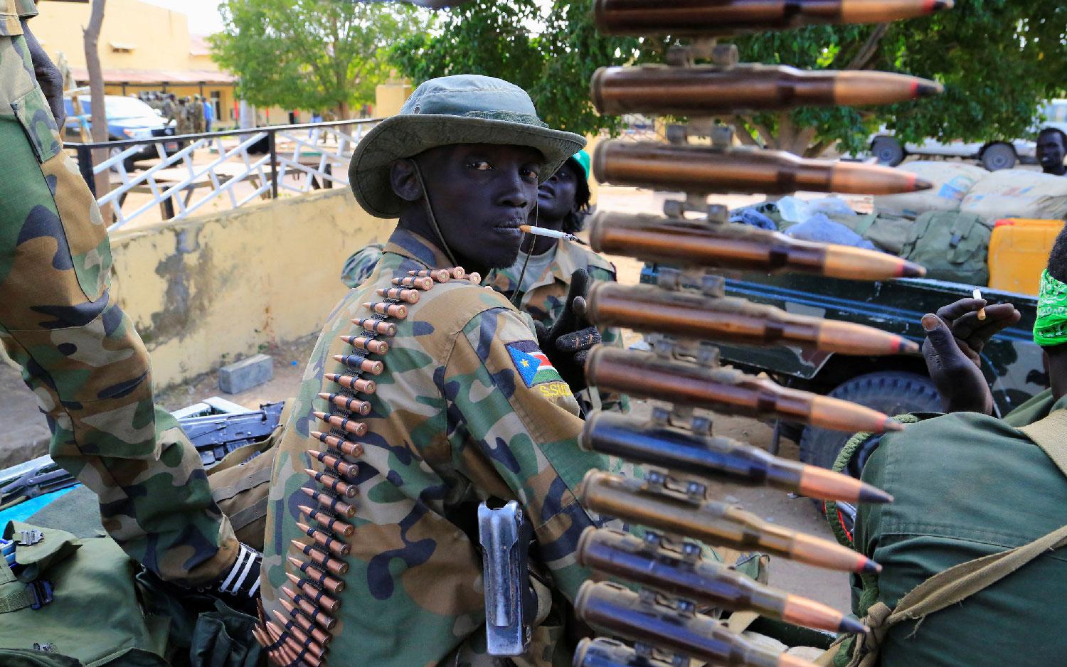 A South Sudanese soldier stands next to a machine gun mounted on a truck in Malakal town, northeast of Juba, South Sudan December 30, 2013. 