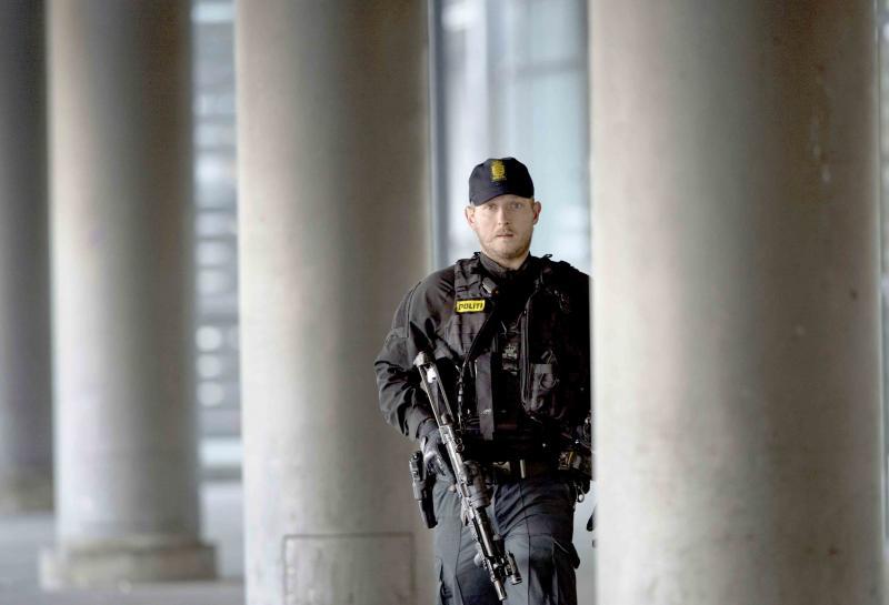 A Danish policeman stands guard outside a building in Copenhagen
