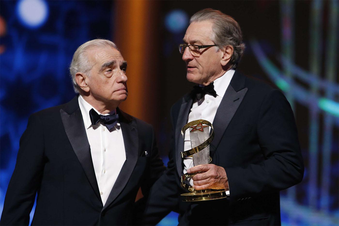 Robert De Niro (R) receiving a tribute award from US director Martin Scorsese to his contribution to acting