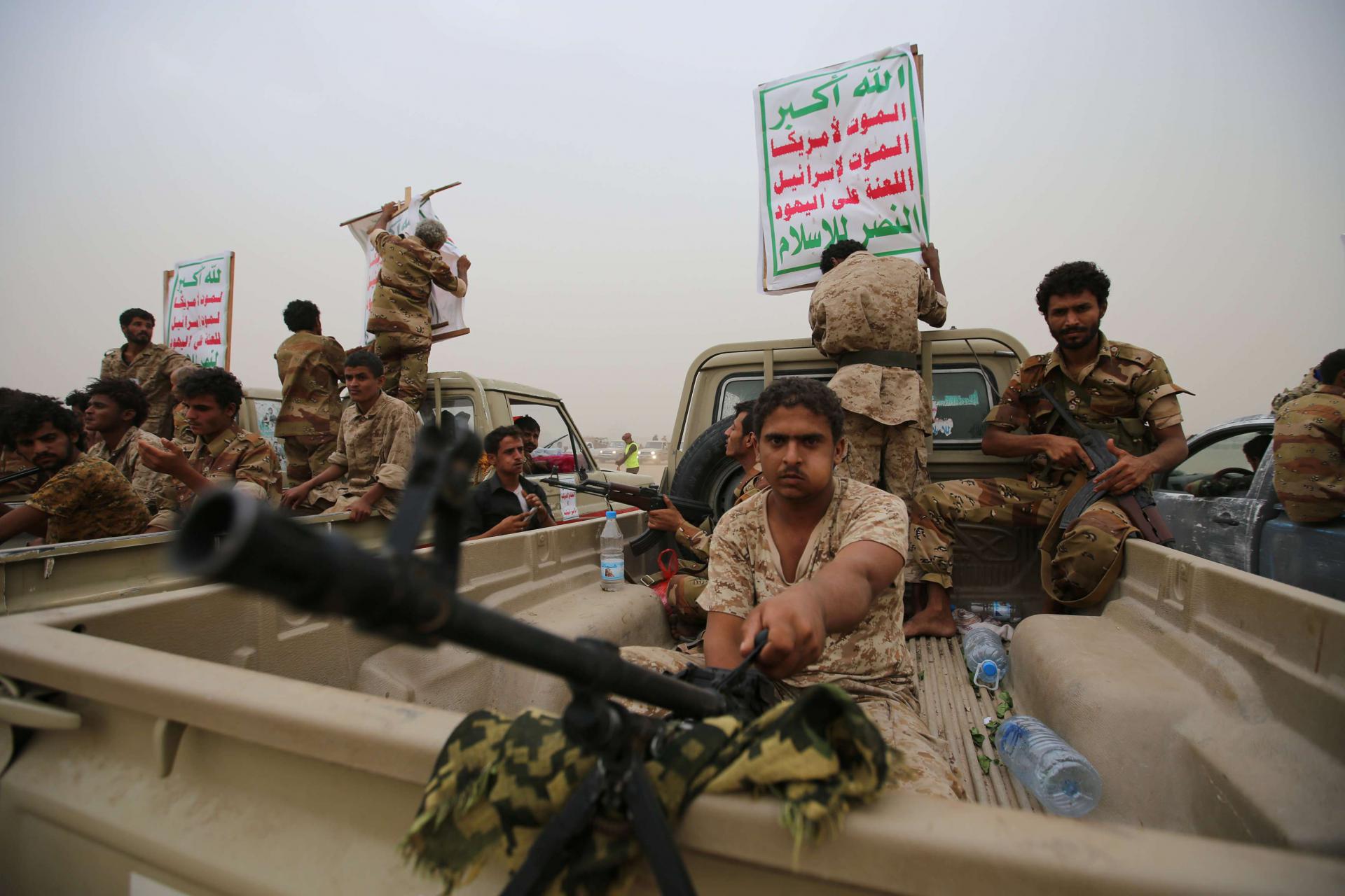 Houthi fighters ride on the back of trucks as they take part in a parade in the Red Sea port city of Hodeidah, Yemen August 24, 2017. 