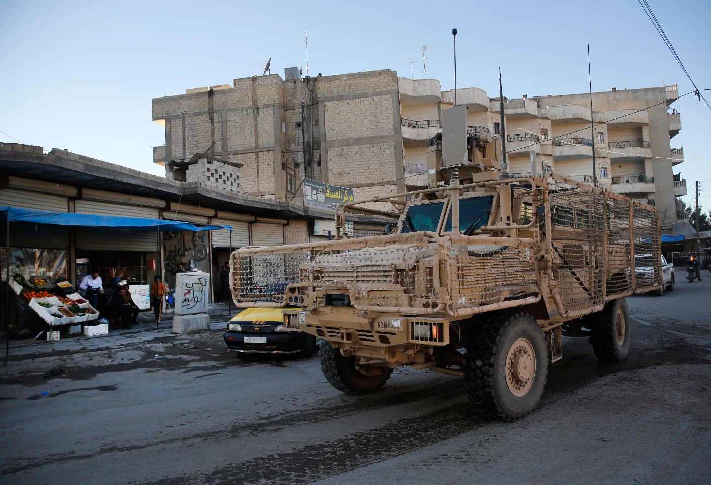 A vehicle of US troops passing on a street, in Manbij town, north Syria on March 31, 2018.