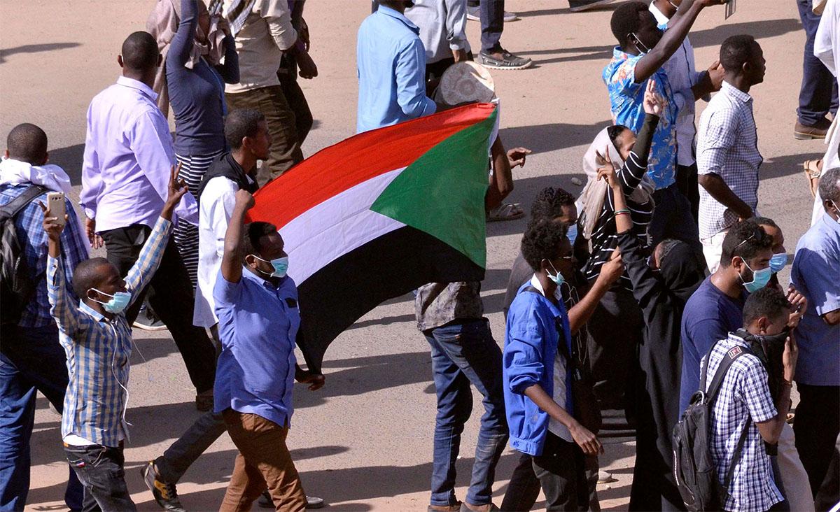 Sudanese demonstrators chant slogans as they march along the street during anti-government protests in Khartoum