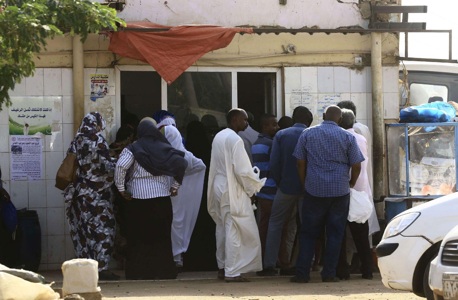 People queue in front of a bakery in the Sudanese capital Khartoum on August 26, 2018.